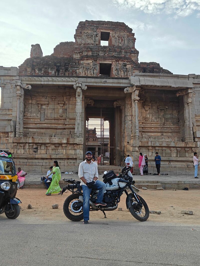 Kratik on a motorcycle outside the gateway of the Krishna Temple, Hampi